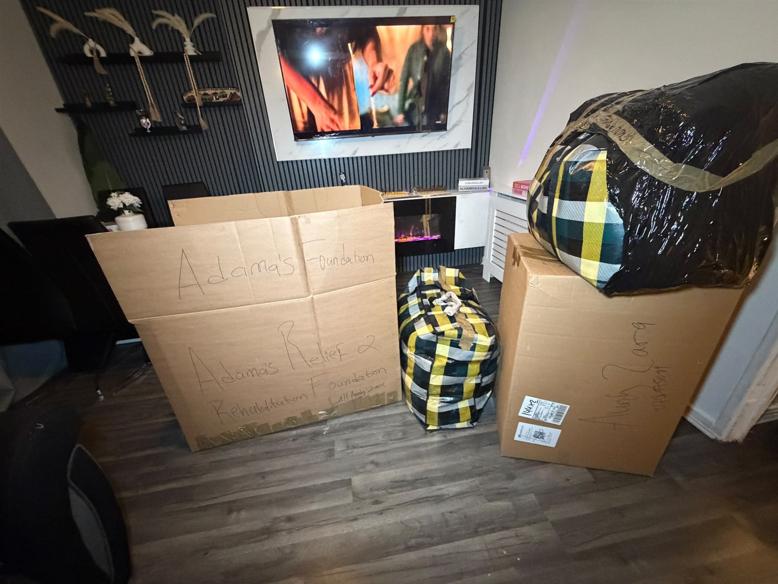 Large boxes and bags of donated clothing prepared for YADAMA community support