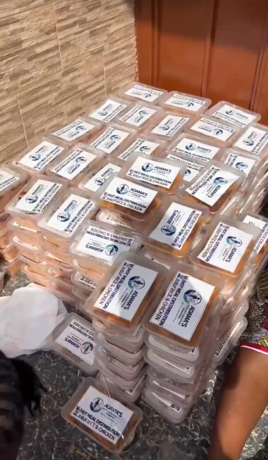 Labelled hot-meal containers stacked and ready for community distribution