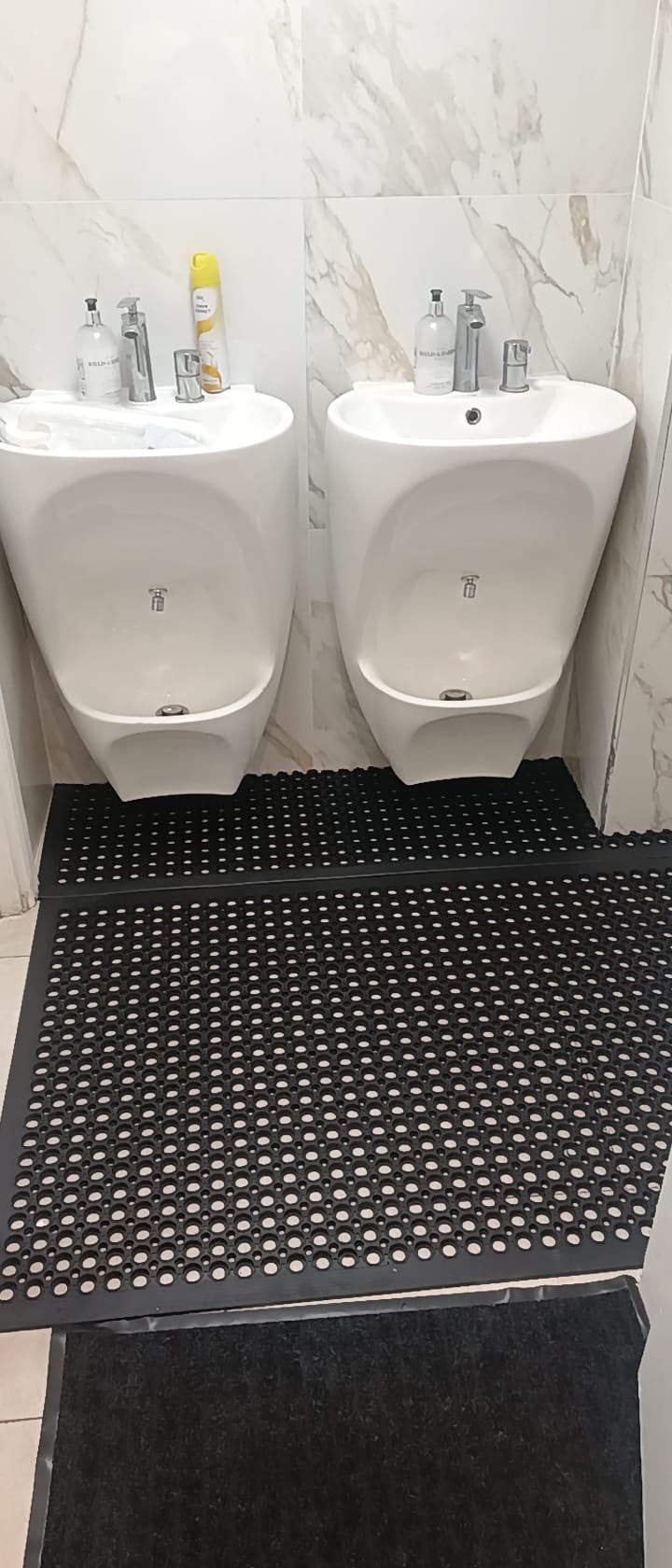 The mosque wudu area after black anti-slip rubber matting was fitted around the washing stations